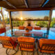 Beautiful outdoor patio with covered pergola and dark bronze solar shade stopping the sun