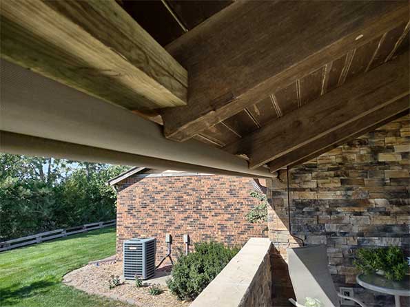 Unique exposed roll shade installation using notched rafters